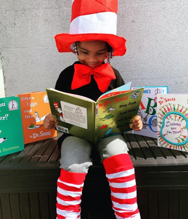 Child reading books in costume